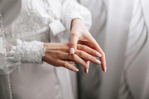 Close-up of an elegant diamond ring on a woman's finger with a modern manicure, sunlight. Love and wedding concept. Soft and selective focus. photo