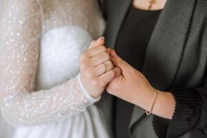 A beautiful and happy mother and her daughter, the bride, are standing next to each other. The best day for parents. Tender moments at the wedding. photo