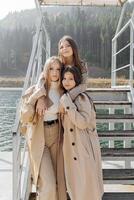 Three beautiful young teenage girls are having fun together outdoors in an Italian town. Urban lifestyle. City center. Best friends in casual clothes. photo
