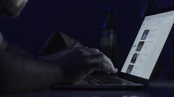 Young man working on computer at night in dark room. The designer works in the later time. Man working on laptop in the dark video