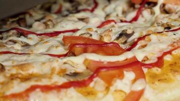 Close up pizza. Frame. Pizza spinning on a plate. Pizza background. Big Italian pizza with black olives, bacon, salami and cheese close up view video