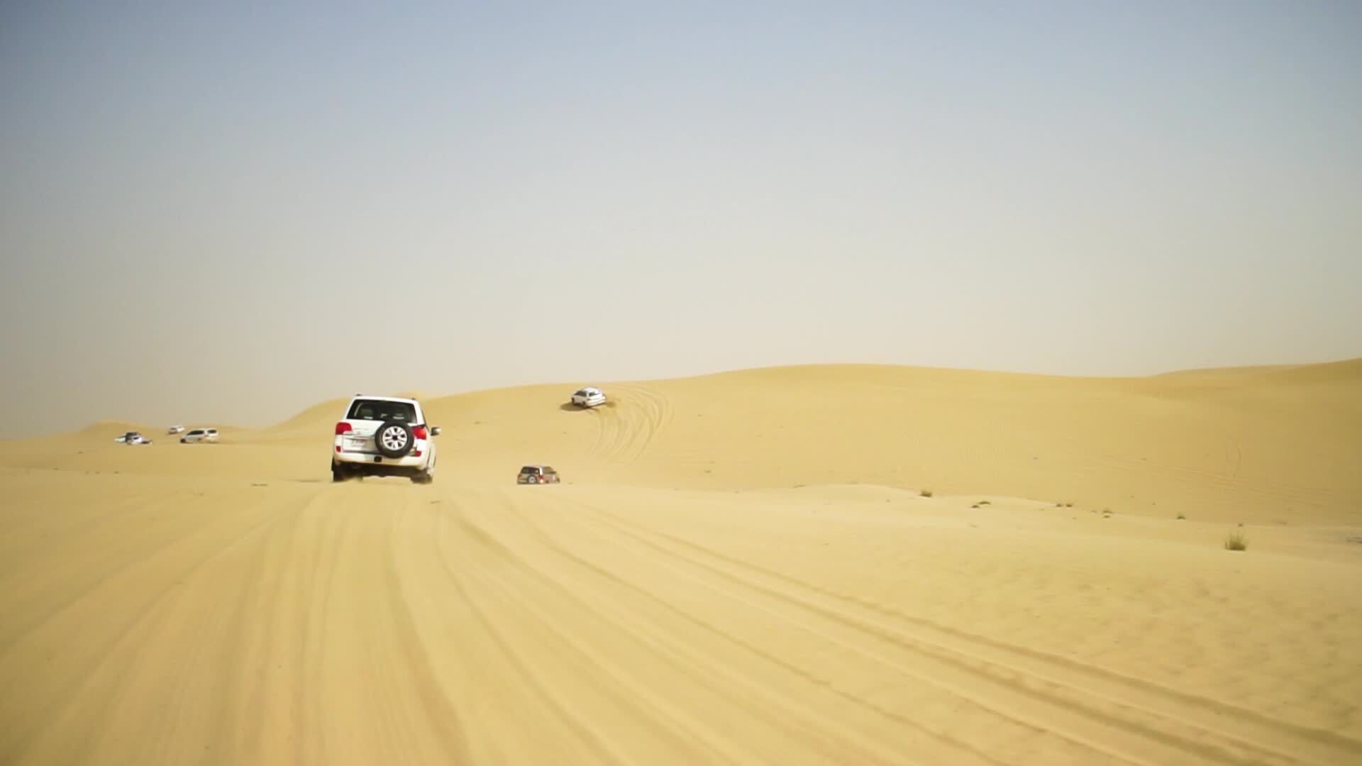 Desert Safari SUVs bashing through the arabian sand dunes. SUV tour