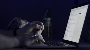 A man's hands working on the laptop at night. The laptop is on the table. View from the top. Close-up shot. Close-up Of A Person's Hand Typing On Laptop. typing in notebook computer. Crime concept video