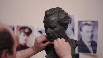 Sculptor created a figure of a man. Clip. Man creates his own hands the bust of a man. Concept art video