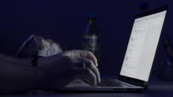 A man's hands working on the laptop at night. The laptop is on the table. View from the top. Close-up shot. Close-up Of A Person's Hand Typing On Laptop. typing in notebook computer. Crime concept video