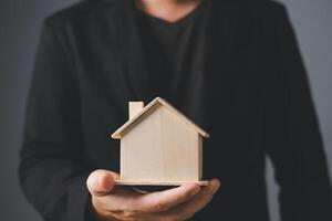 the businessman holding a piggy bank, donation, charity, fundraising, superannuation, investment, saving, family finance plan concept, Money Saving Ideas for Buying a Home. photo