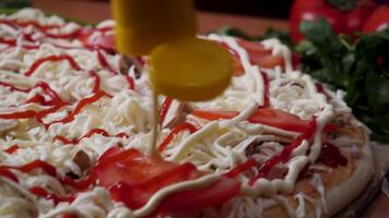 Hands preparing a pizza. Frame. Cook in the kitchen putting the ingredients on the pizza. Pizza concept. Production and delivery of food. Closeup hand of chef baker in white uniform making pizza at video