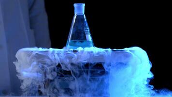 Bottle and liquid nitrogen in a laboratory. Chemical experiment. Flask with water and dry ice boiling chemical experiment video