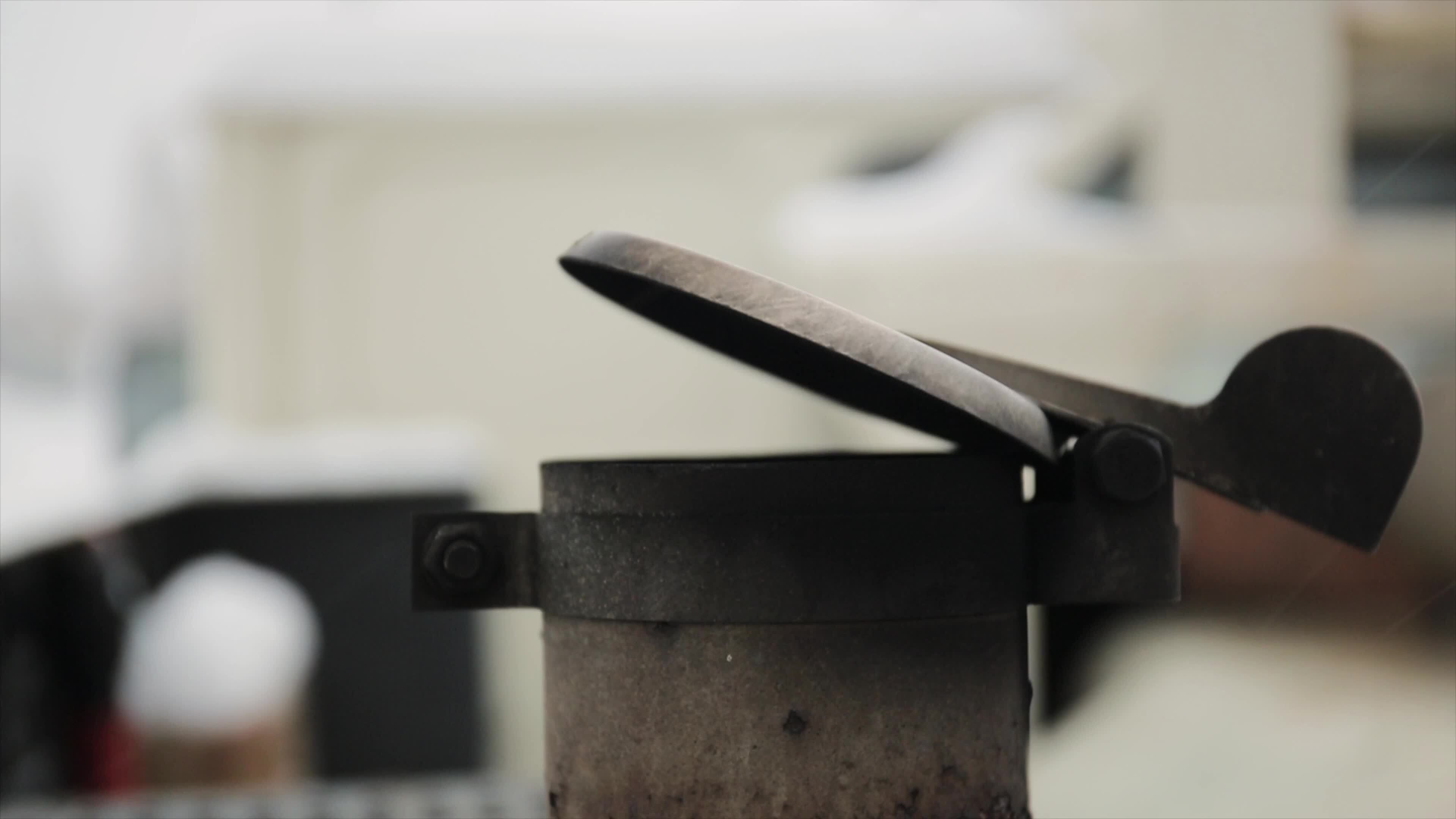 A tractor exhaust pipe with muffler and rain flap and rust. Exhaust