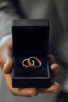 wedding rings close-up in hand. She says yes. Gold wedding rings with engraving photo