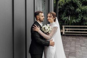 Portrait of happy wife and husband hugging in restaurant and smiling. Sincere feelings of two young people. The concept of true undying love. photo