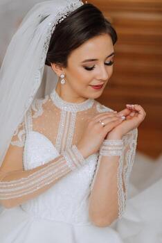 fashion portrait of a beautiful bride in a luxurious wedding dress with lace and crystals in an Arabic interior style. Beautiful bride with a bouquet of flowers. Preparation for the wedding ceremony. photo