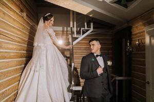 portrait of a happy bride and groom in the hall of a modern hotel near the stairs. Winter wedding. photo