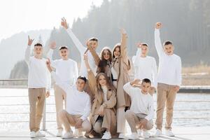 friendship, movement, action, freedom and people concepts - group of happy teenage students or school friends posing and having fun outdoors on beautiful place background. photo