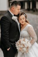 Wedding couple in love. A beautiful bride and an elegant groom tenderly embrace and enjoy the day. A stylish couple of newlyweds. Concept of marriage photo