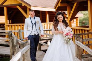 un hermosa joven novia, en un verano parque, camina adelante de su novio. hermosa Boda blanco vestido. camina en el parque. un contento y amoroso Pareja. foto