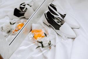 Details of the bride. Beauty is in the details. High-heeled bridal shoes. Gold wedding ring with a diamond. Perfumes. Earrings Wedding in details. photo