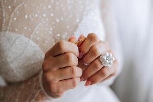 Close-up of an elegant diamond ring on a woman's finger with a modern manicure, sunlight. Love and wedding concept. Soft and selective focus. photo