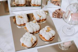 Almond cookies and various sweet cakes for a wedding banquet. A delicious reception, a luxurious ceremony. Table with sweets and desserts. Delicious colorful French desserts on a plate or table. photo