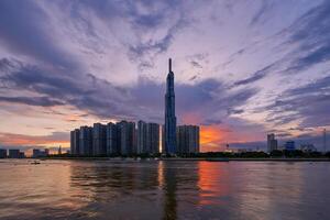 Ho Chi Minh City, Viet Nam 26 Oct 2023 Beautiful Sunset at Landmarks 81 Ho Chi Minh City, the tallest building in Vietnam, with Vietnam flag on the top building. photo