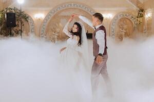 the wedding of the bride and groom in an elegant restaurant with great light and atmosphere. The first dance of the bride and groom. photo