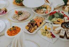 Top view of a beautifully decorated table with delicious food. Everything is ready for lunch or dinner with delicious snacks and a cozy atmosphere. photo