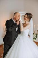 A beautiful bride with her father on her wedding day. The best moments of the wedding day. Daughter and father. photo