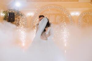 the wedding of the bride and groom in an elegant restaurant with great light and atmosphere. The first dance of the bride and groom. photo