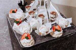 almendra galletas y varios dulce pasteles para un Boda banquete. un delicioso recepción, un lujoso ceremonia. mesa con dulces y postres delicioso vistoso francés postres en un plato o mesa. foto