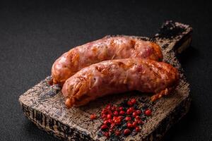 Delicious grilled chicken or pork sausages with salt and spices photo