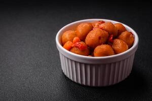 Delicious fried potato balls with vegetables, salt, spices and herbs photo