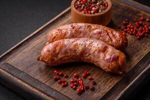 Delicious grilled chicken or pork sausages with salt and spices photo