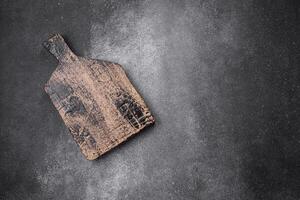 Empty wooden cutting board on a light texture background photo