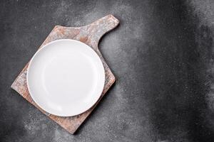 Empty round ceramic plate on a light texture background photo