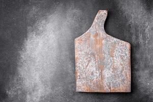 Empty wooden cutting board on a light texture background photo