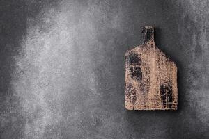 Empty wooden cutting board on a light texture background photo