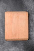 Empty wooden cutting board on a light texture background photo