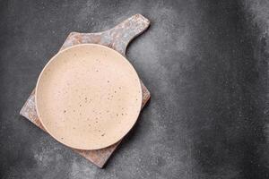 Empty round ceramic plate on a light texture background photo