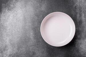 Empty round ceramic plate on a light texture background photo