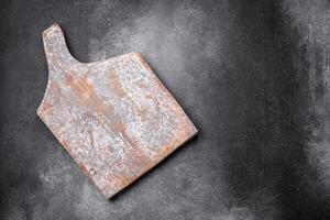 Empty wooden cutting board on a light texture background photo