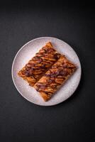 Delicious crispy sweet puff pastry with chocolate and salted caramel photo