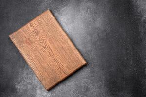 Empty wooden cutting board on a light texture background photo