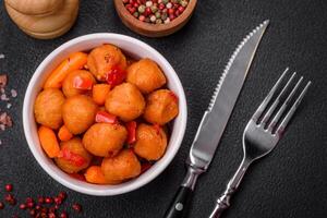 Delicious fried potato balls with vegetables, salt, spices and herbs photo