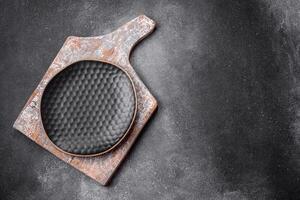 Empty round ceramic plate on a light texture background photo