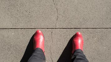 Red boots, seen from above, about to cross a line photo