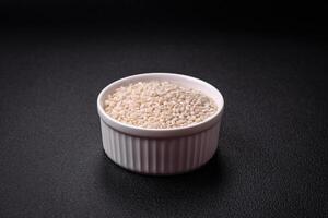 Large grains of uncooked white rice in a ceramic bowl photo