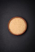 Large grains of uncooked white rice in a ceramic bowl photo