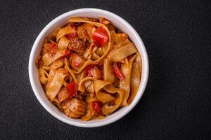 Delicious asian udon dish with vegetables, mushrooms, salt and spices photo