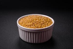 Bulgur wheat grains are yellow in color when raw photo