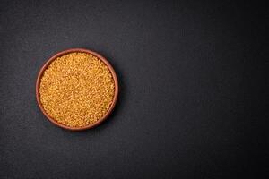 Bulgur wheat grains are yellow in color when raw photo